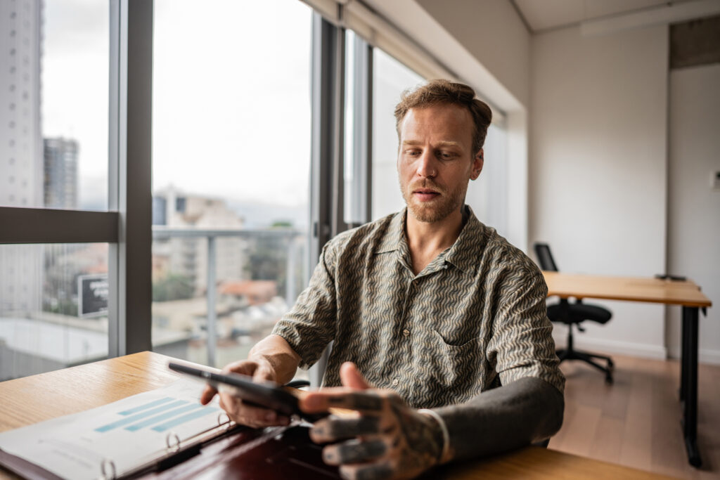 Man using smartphone in office- Fair Work Agency